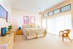 Bedroom is spacious, has under high ceiling and louvers that allow tropical breezes to cool the room